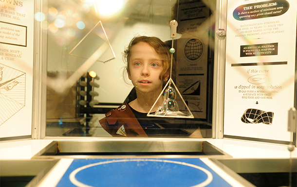 Girl Scout brownie looking into a display case at a museum