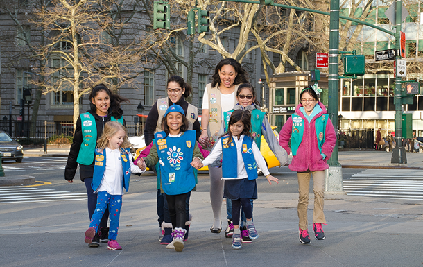 Two girl scouts playing hand games