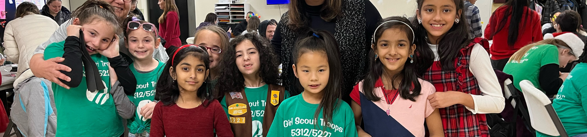  Girl Scout members of a Unique Abilities Troop and their troop leader share resources and information about accessibility at Girl Scouts of Greater New York's annual gala. 