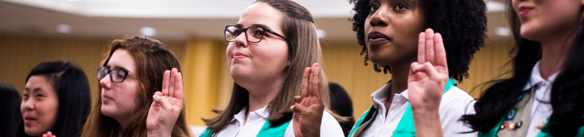  girl scout ambassador high school girl in school wearing sash with highest awards pins 