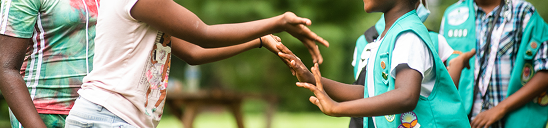  two girl scouts playing hand games 